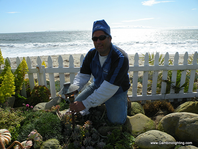 Mike Gambino in February 2012 cleaning a first generation copper Gambino "torino" spreadlight fixture that was installed 30 feet from the Pacific ocean. One of the most brutal environments possible. Besides some bird droppings on its cap the fixture is in excellent condition with no signs of degrading.
